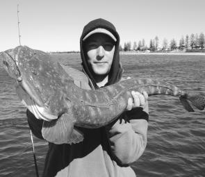Toby with his monster flattie from Botany Bay, caught on a black opal Squidgy Shad and released after a picture or ten.